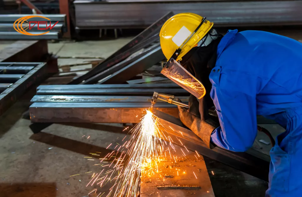 Worker Welding Steel Beams for Structural Steel Fabrication